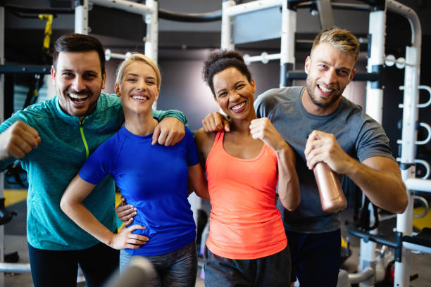 istock Group of young friends people doing exercises in gym 1268270884