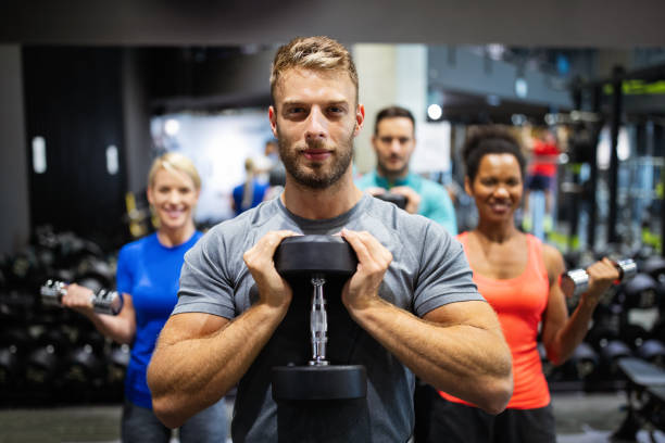 istock Group of young friends people doing exercises in gym 1268270933