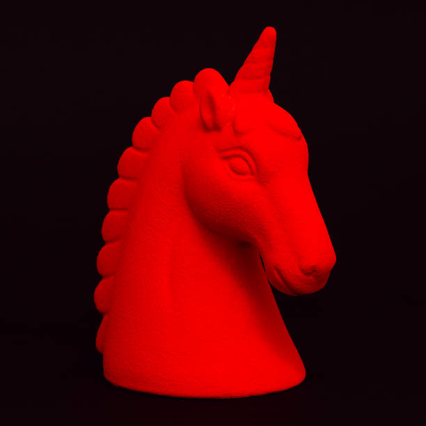 istock Red unicorn souvenir on a black background. Minimal 1268270943