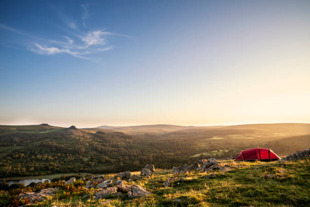 stunning image of wild camping in english countryside during stunning summer sunrise with warm glow of the sun lighting the landscape - dartmoor imagens e fotografias de stock