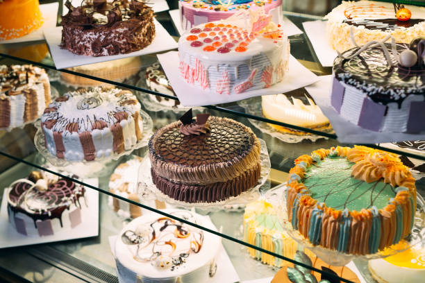 istock Pastry shop glass display with selection of cream or fruit cake. 1268273032