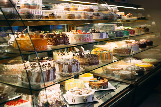 Pastry shop glass display with selection of cream or fruit cake. stock photo