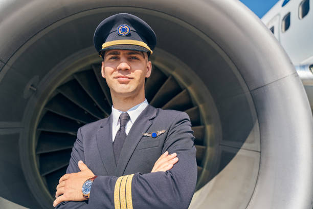 istock Qualified stylish pilot in uniform looking ahead 1268273460