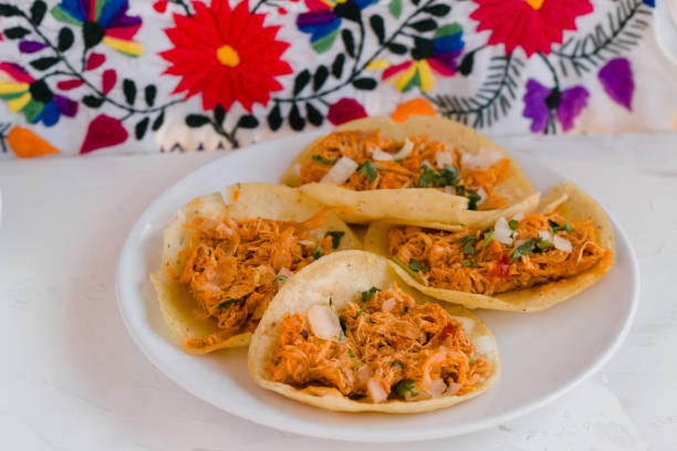 istock Traditional tacos with tinga de pollo on embroidered tablecloth from Mexico 1268275486