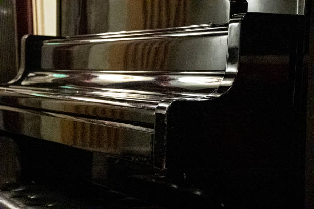 istock Close up of a black upright piano reflecting light 1268283363