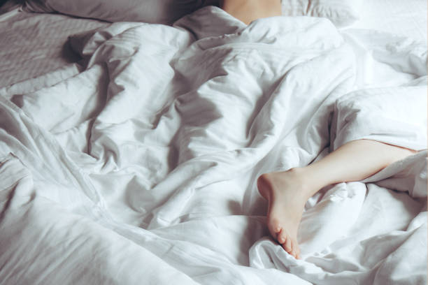 istock Female leg on white bedding 1268283648