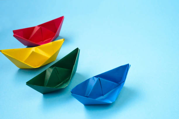 istock Bright colored origami paper boats. 1268283787