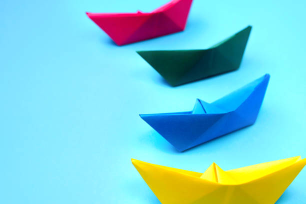 istock Bright colored origami paper boats. 1268283792