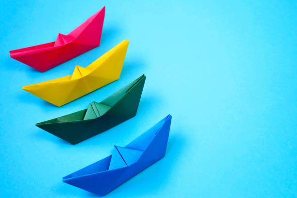 istock Bright colored origami paper boats. 1268283798
