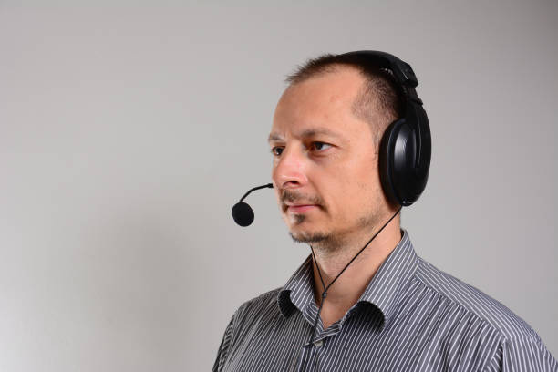 istock Handsome man in work in call-center with headphones. 1268285880