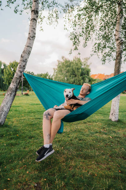 istock Man laying in hammock with the  dog 1268286209
