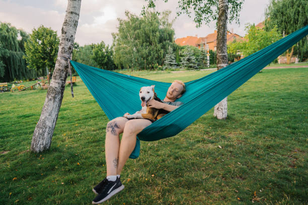 istock Man laying in hammock with the  dog 1268286222