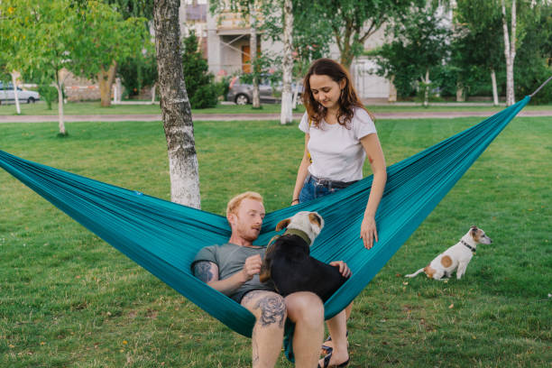 istock Woman petting dog while man  laying in hummock with it 1268287236