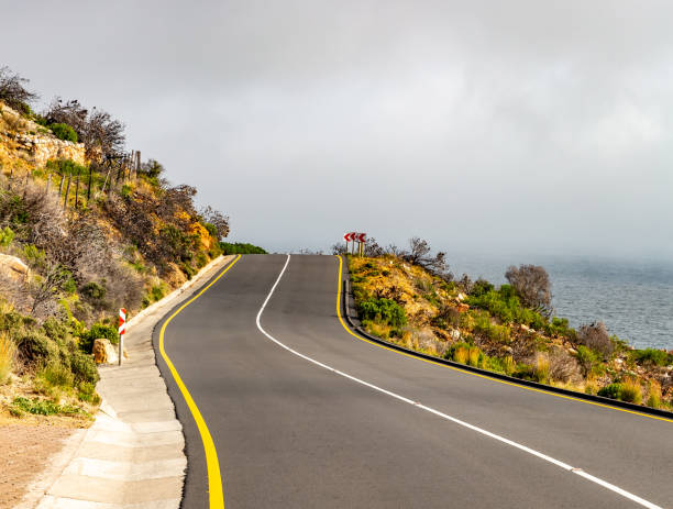 Chapman's Peak Drive near Cape Town in South Africa The Chapman's Peak Drive on the Cape Peninsula near Cape Town in South Africa on a bright and sunny afternoon. chapmans peak drive stock pictures, royalty-free photos & images