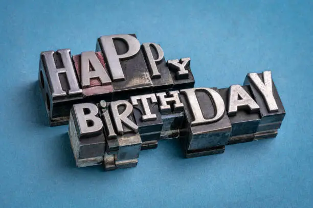 Happy Birthday greetings  in vintage metal type printing blocks over handmade rag paper