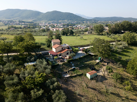 Aerial view of italian house in the village Frasso Sabino Lazio communa, Italy, Europe. Mountains hills olive trees green meadows around. Italian countryside rural landscape.
