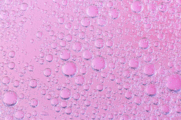 istock oil with bubbles on coral background. Pink Abstract space background. Soft selective focus. macro of oil drops on water surface. copy space. air bubbles in water, 1268290898