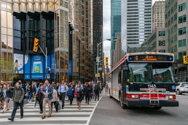 TORONTO, CANADA - MAY 09, 2018: Toronto's busiest intersection Yonge and Front Streets in a rush hour.  High - rise buildings  of the Financial district at the backgroundt