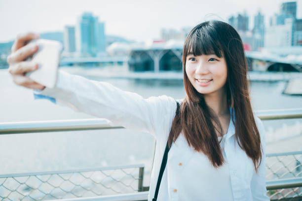 istock Asian woman smile take selfie 1268292223