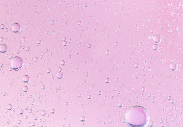 istock oil with bubbles on coral background. Pink Abstract space background. Soft selective focus. macro of oil drops on water surface. copy space. air bubbles in water, 1268292244