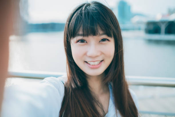 Asian woman smile take selfie Asian woman smile take selfie photographing herself stock pictures, royalty-free photos & images
