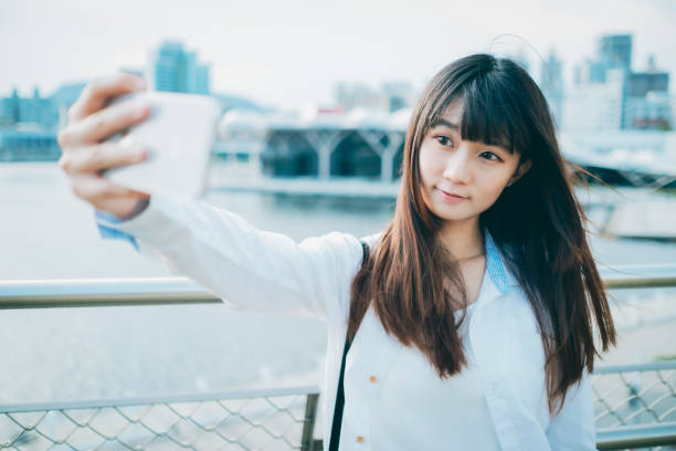 istock Asian woman smile take selfie 1268292261