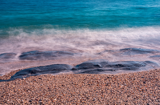 Long exposure (over 60secs) of surf on the beach of Lantic Bay, Cornwall