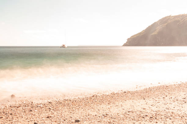 Long exposure (over 60secs) of surf on the beach of Lantic Bay, Cornwall