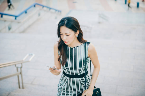 istock Busy businesswoman using smartphone in city 1268294744