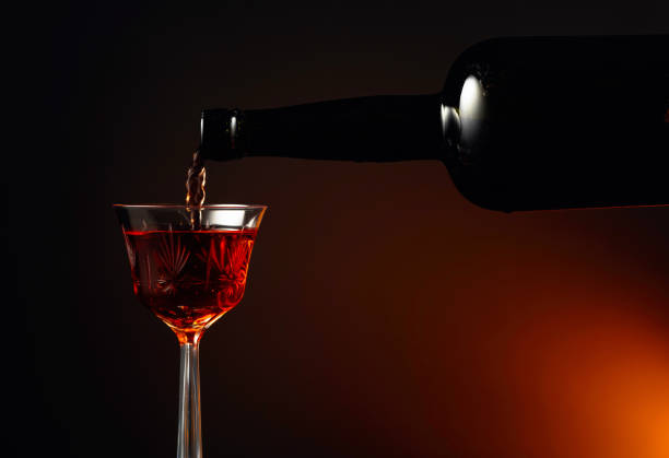 Aged golden fortified sherry being poured into a crystal glass.