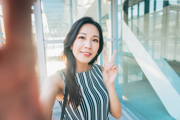 istock Asian businesswoman taking a selfie 1268295249