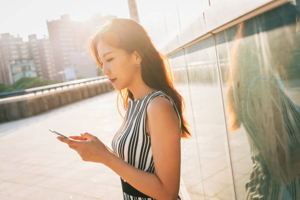 istock Busy businesswoman using smartphone in city 1268295285