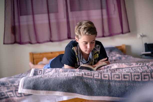 istock A boy is reading a book at home 1268296457