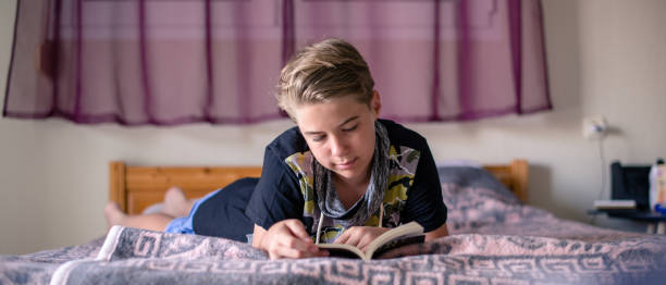 istock A boy is reading a book at home 1268296495
