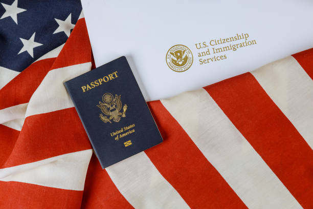 istock Immigration concepts with US passport and flag over a citizenship 1268296527