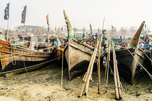 Chittagong, Bangladesh, December 23, 2017: Traditional fishng boats at the port on Karnaphuli River in the morning