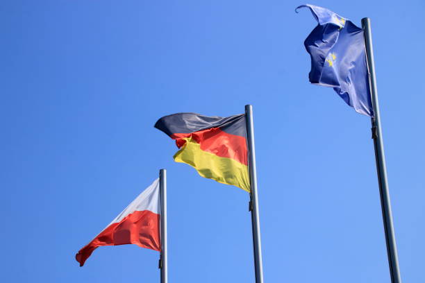 istock Flags fly in front of a blue sky in the wind 1268297477