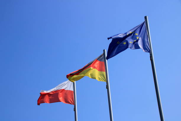 istock Flags fly in front of a blue sky in the wind 1268297561