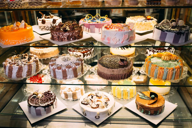 istock Pastry shop glass display with selection of cream or fruit cake. 1268298631