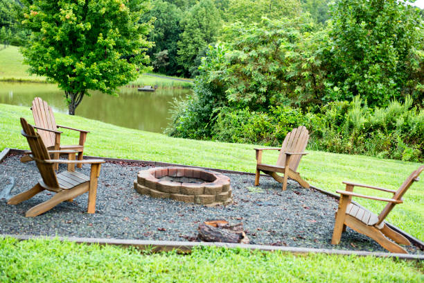 istock Firepit sits in yard in front of relaxing, wooded pond area 1268298675