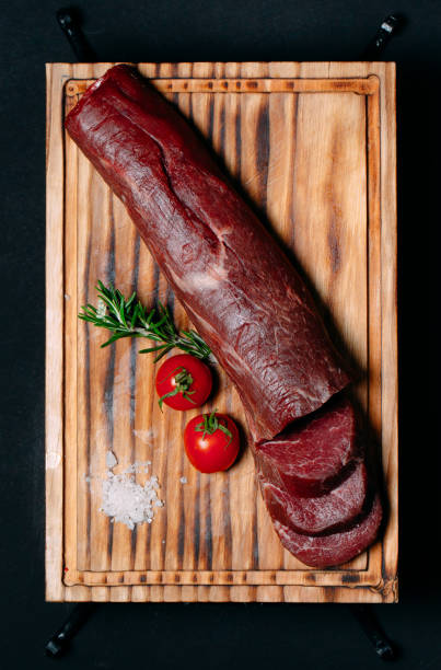 istock Raw tenderloin meat on a black background. 1268298931