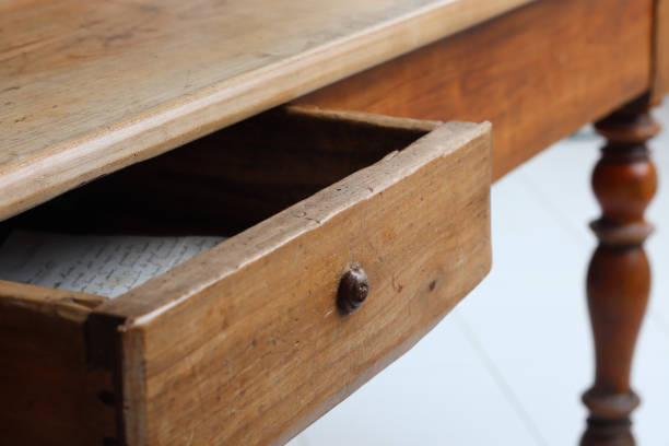 istock Old vintage wooden table with half-open drawer 1268300335