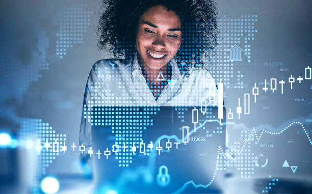 istock Smiling African woman in office, financial chart 1268301843