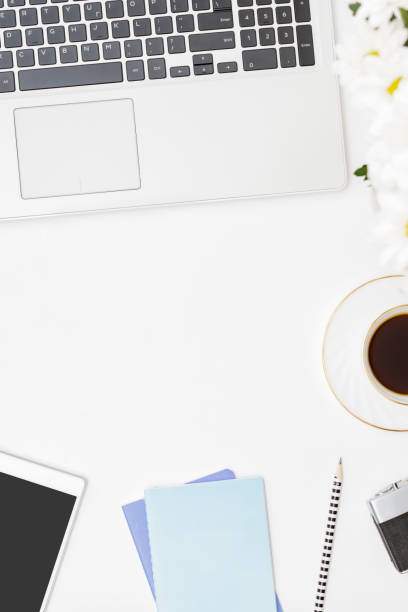 istock Flat lay blogger or freelancer workspace with a notebook, laptop a cup of coffee on a white background 1268302887