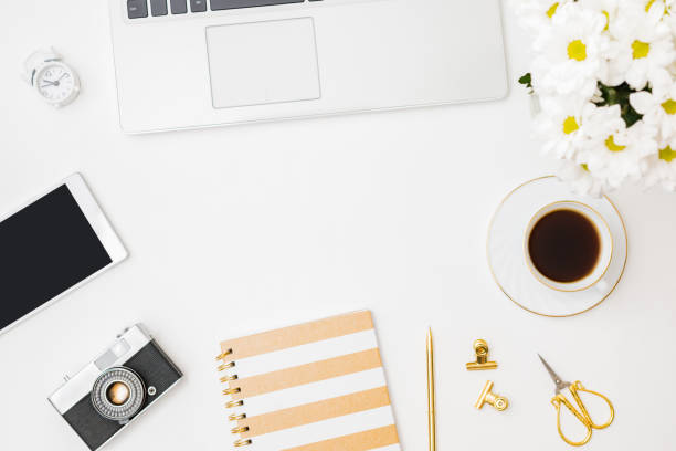 istock Flat lay blogger or freelancer workspace with a notebook, laptop a cup of coffee on a white background 1268302894