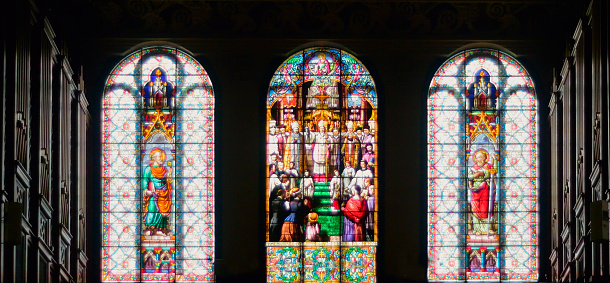 A colorful gothic stained glass window with patterns