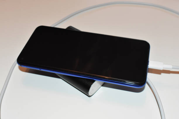 istock Mobile phone charging via external portable battery 1268303998
