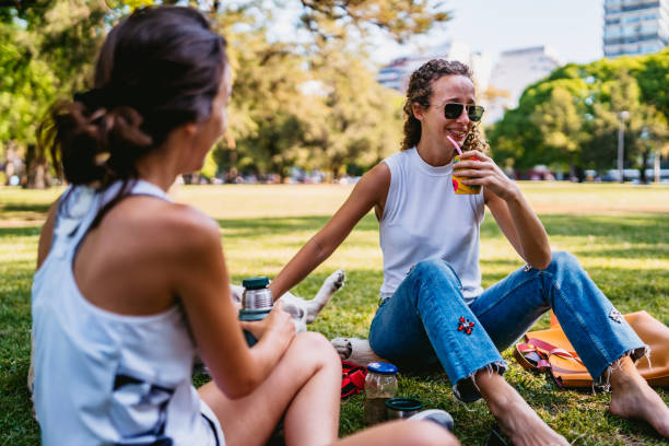 istock Two women and dog relaxing in park 1268304584