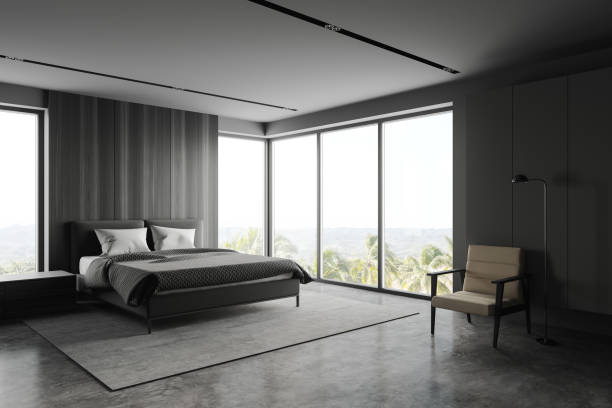 istock Grey and wooden bedroom corner with armchair 1268304721