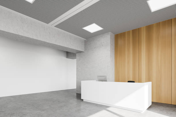istock Reception desk in white and wooden office corner 1268305315